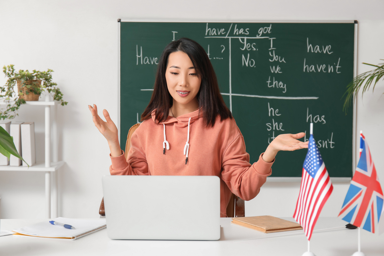 Female English Teacher Giving Online Grammar Lesson in Classroom