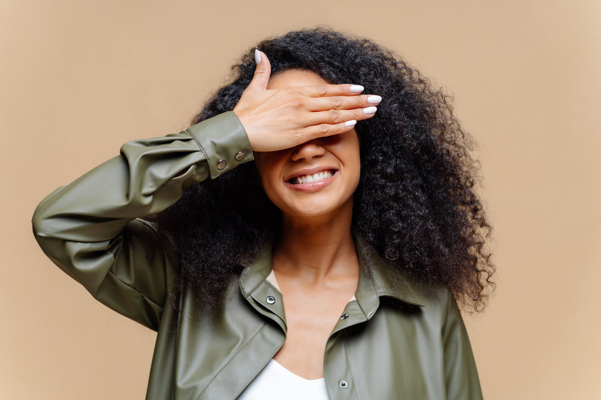 Shy Cheerful Young Woman Covers Eyes 